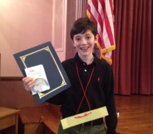 Sixth grader Ethan L. holds his certificate after winning second place at the DC Geography Bee.