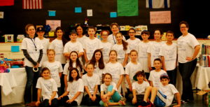 Sixth grade students pose together at the Shuk for Shalom.