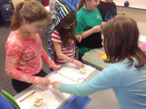 Students play a tile-based game at the Fifth Grade Math Carnival.