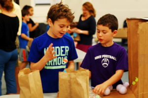 Students play cardboard arcade games together.