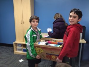 Students help sort and carry donations at A Wider Circle during Yom Chesed.