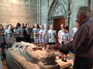 Students listen during a tour of The Cloisters museum.