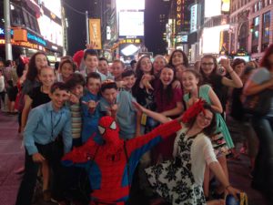 Students pose with Spider-Man in Times Square.