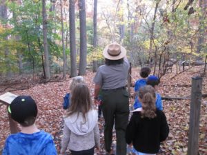 A Park Ranger leads first grade students on a hike.