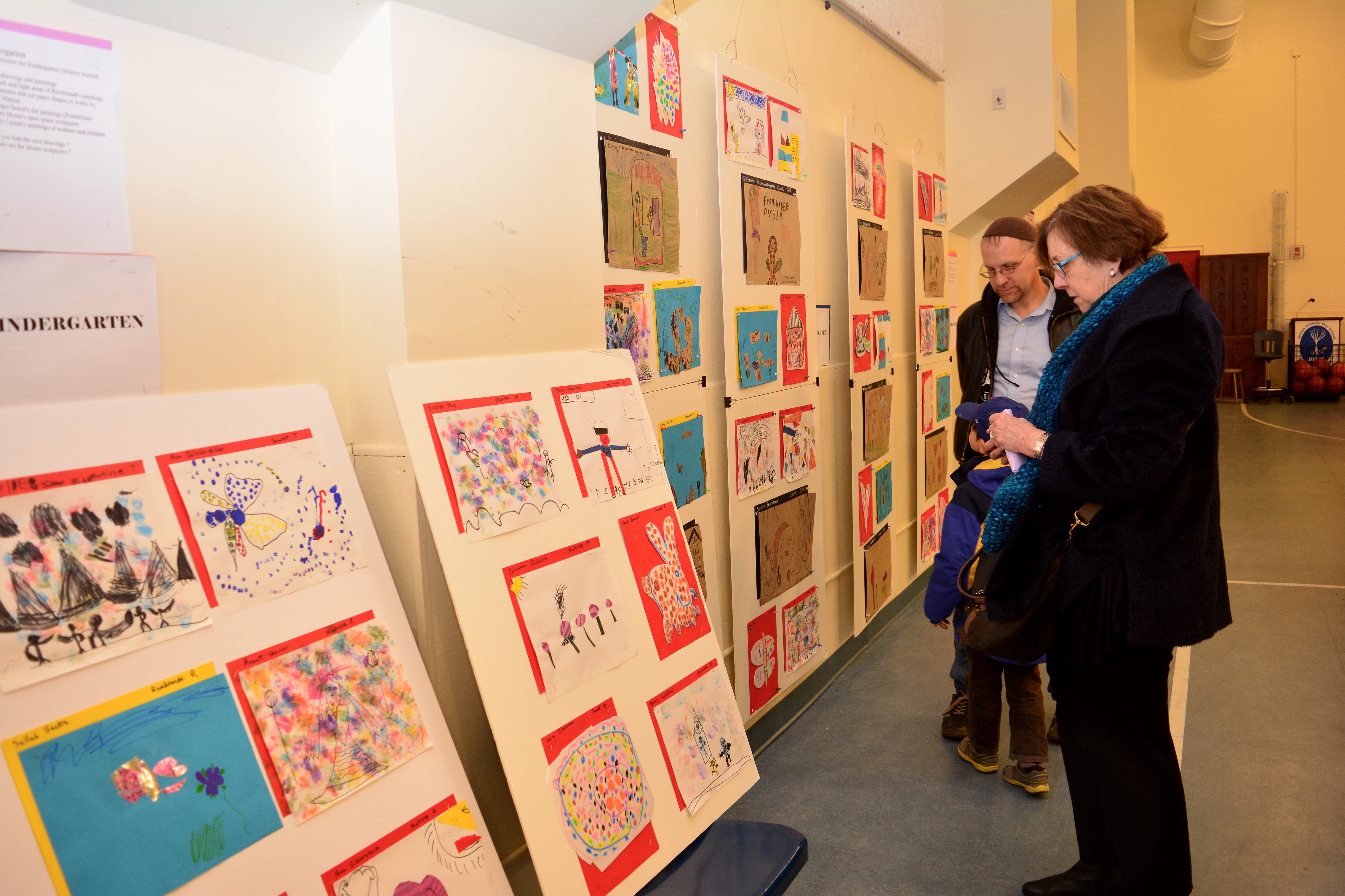 A parent views the gallery of student artwork.