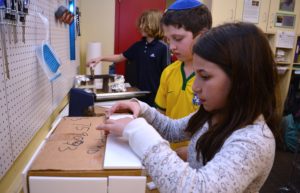 Two students use Design Lab equipment for their prototypes.