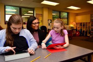 Hebrew teacher and Instructional Leader Shoshana Sfarzada works with students on their family immigration documentary films.