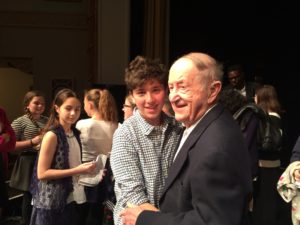 Holocaust survivor Rubin Sztajer gives a hug to a JPDS-NC student.