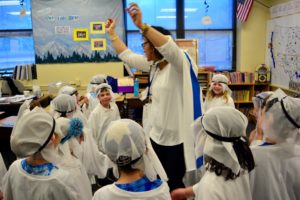 Hebrew teacher Gili Bitton dances with students.