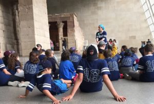 Students sit in the antiquities exhibit at the Metropolitan Museum of Art.