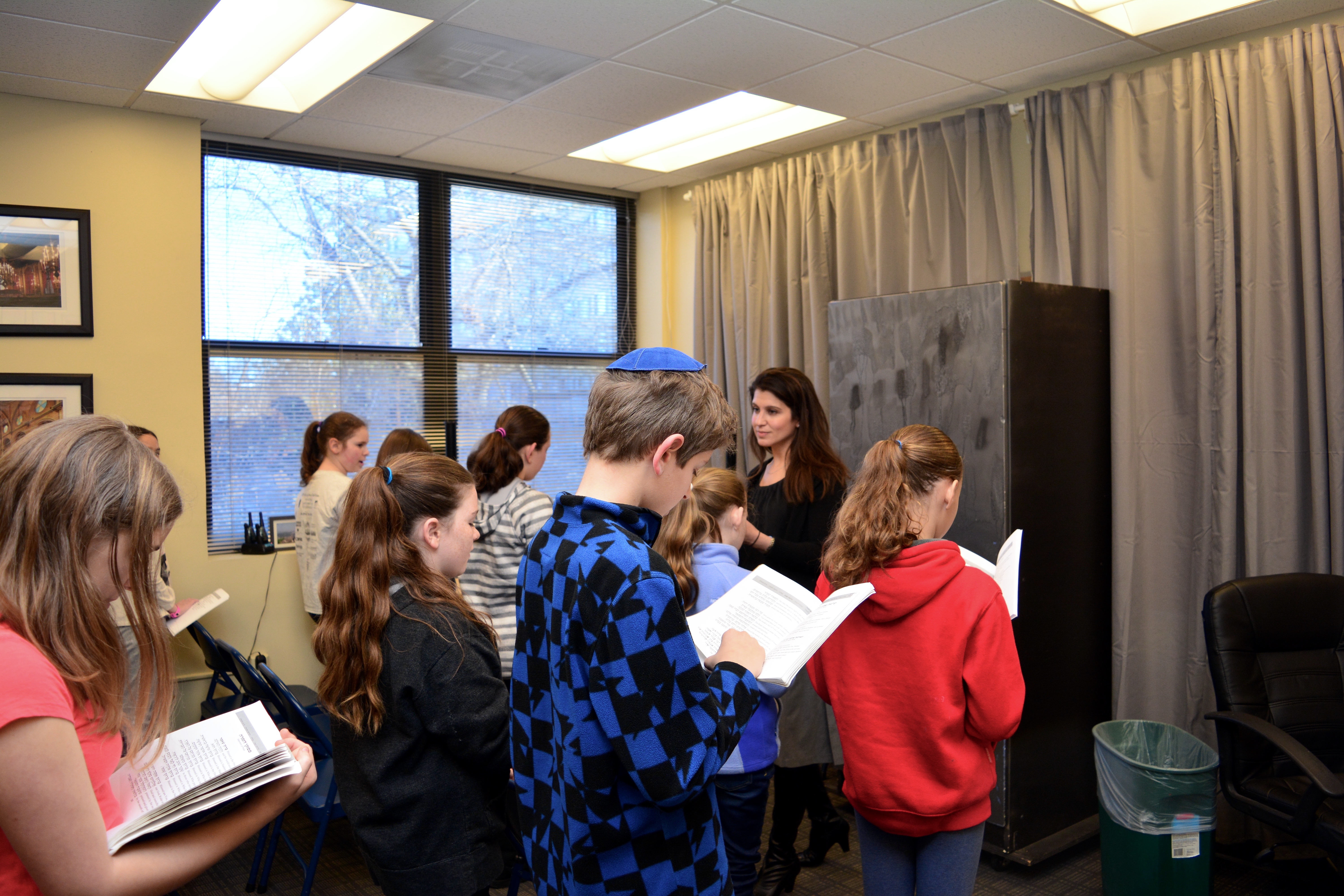 Lisa Schopf leads tefilah (prayer) with a group of sixth grade students.