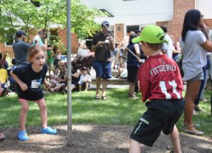 Two students play tetherball at the New Family Summer Brunch.