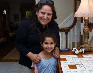 A mother and her child smile for the camera.