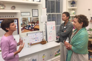 Kindergarten teacher Lisa Davis leads guests through a classroom.