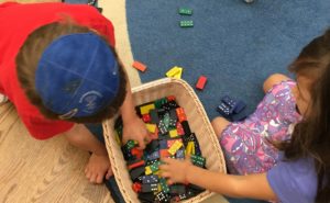 Kindergarten students sort dominoes as part of their Foundations learning in math.