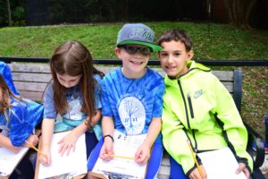 Two students pose smiling on a bench at the National Zoo.