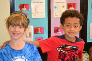 A second grader poses for a smile with his new friend from the Horace Mann School.