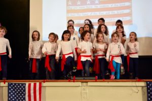 First graders sing and dance to "You're a Grand Old Flag" at the annual JPDS-NC Veterans Day Performance.