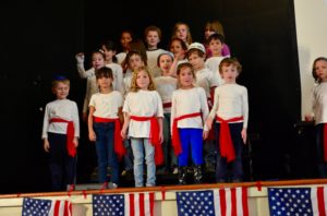 First graders sing and dance to "You're a Grand Old Flag" at the annual JPDS-NC Veterans Day Performance.