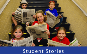 Students pose with copies of the Northwest Current, a local newspaper.