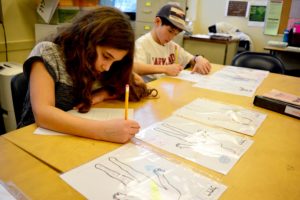 Students draw symbols to use for their biblical character profiles.