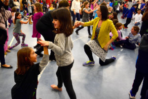 Two students partner together in an Israeli dance.