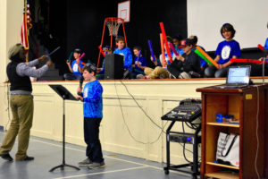 The JPDS-NC choir performs at the Dance-a-Thon, led by Music Specialist Javon Morris-Byam.