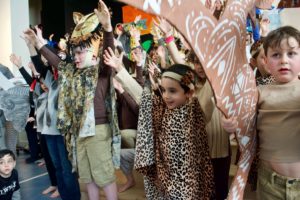 Cheetahs and lions sing together during the opening number of "The Lion King."