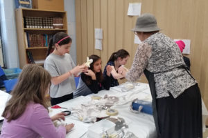 Sixth graders sculpt with clay.