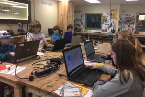 Sixth graders work on laptops.