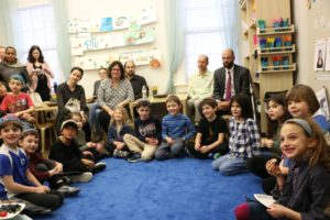 First graders and their families gather in a circle at the first grade Bayit Patuach (Open House).