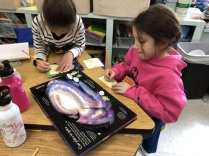 Second graders conduct research on outer space for their STEM Night creations.