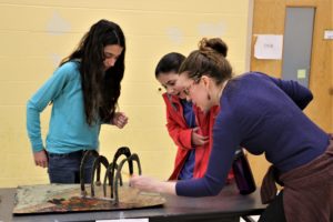 Sixth Grade Teacher Fani Bettman plays a student's 3-dimensional, Odyssey-inspired board game.