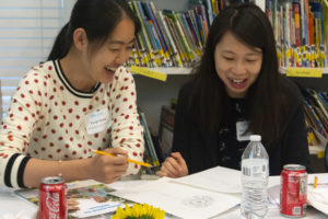 Two participants work on a project together at the Community Day of Learning.