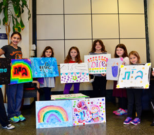 Students show off their artwork created for Bikur Cholim of Greater Washington.