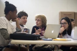 Evelyn Idelson, 91, consults with, from left, Savannah Waymer, 14, Jonah Docter-Loeb, 15, and Hannah Docter-Loeb, 17, at the Chevy Chase Library.