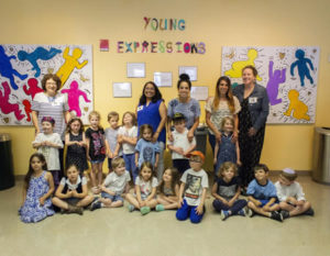 Pre-kindergartners and their teachers pose in front of the mural, which is hanging in the "Young Expressions Gallery" of Children's Hospital.