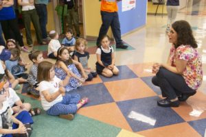 Students have a conversation with one of the employees about the hospital's gallery.