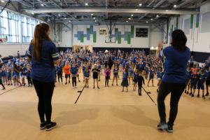 Nearly 500 Students and staff have fun Israeli dancing in the school's new regulation-size gym.