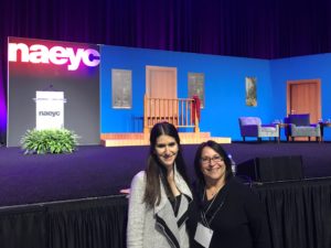 Pedagogista Laura Cohen and Atelierista Judy Kimel pose in front of the set from the television show "Mr. Rogers Neighborhood."