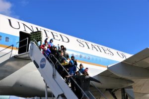 Students pose on the steps of a retired Air Force One plane, which has been turned into a museum.