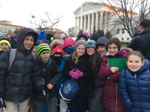 Students pose outside of the Supreme Court as they wait for oral arguments to begin.